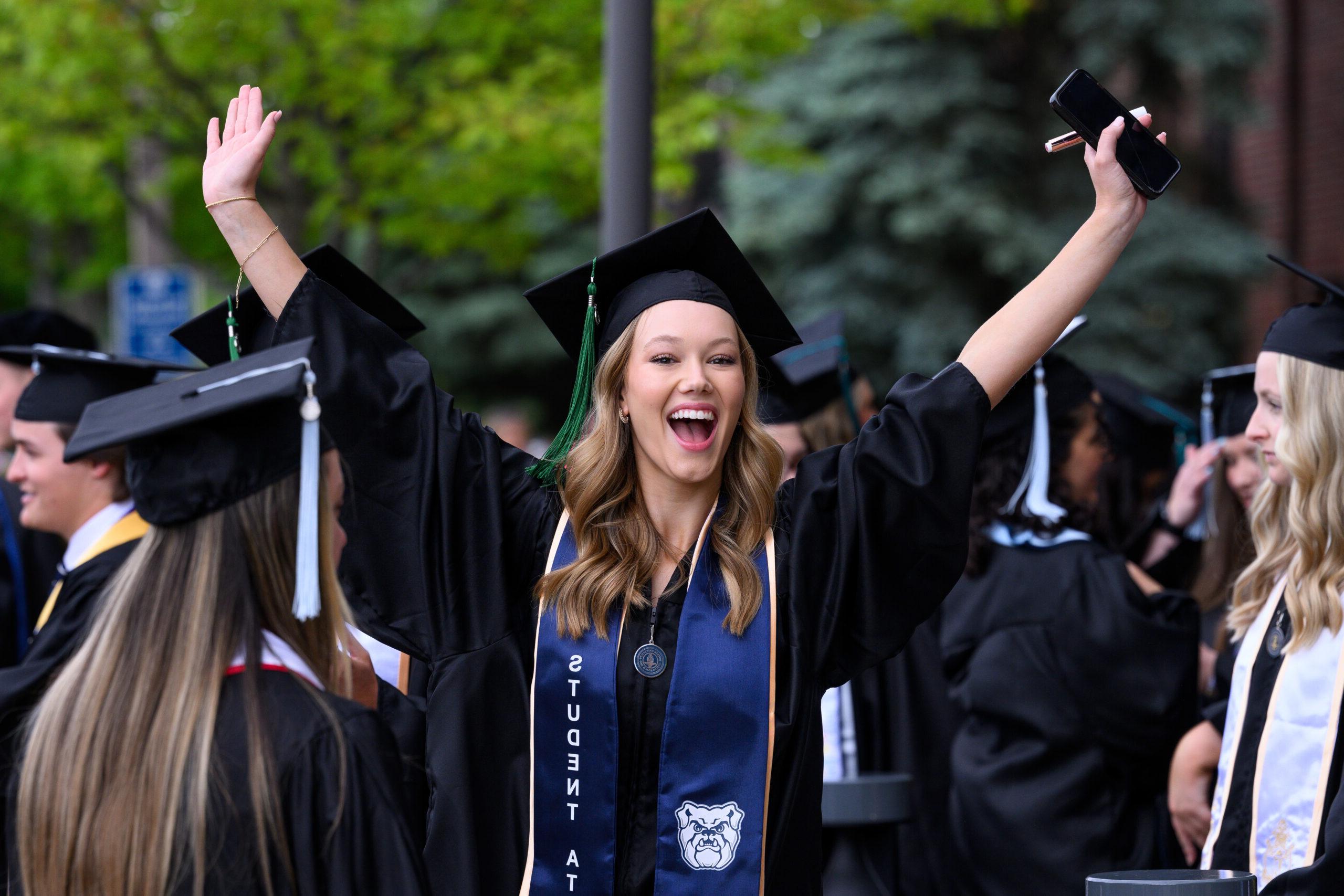 Female 博彩平台排名 graduate excited at Commencement ceremony.